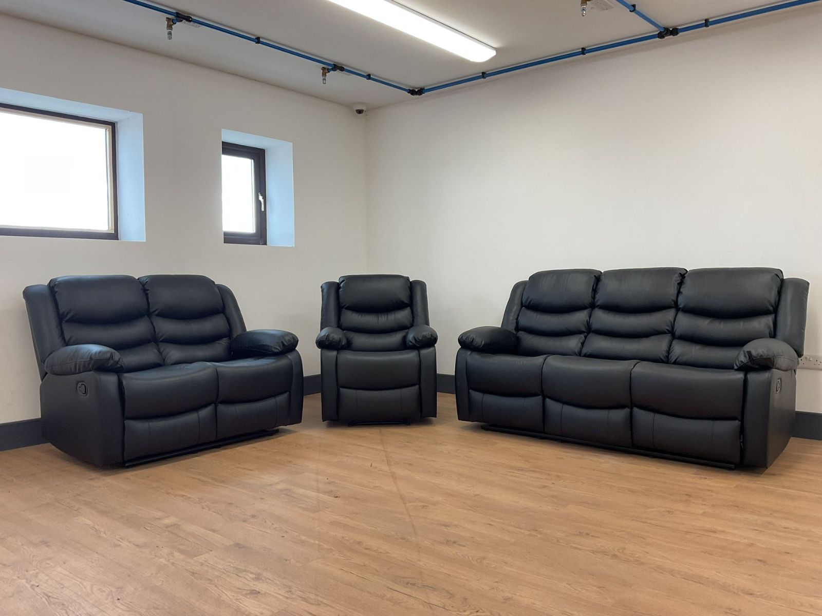 Conrad Black Faux Leather Manual Reclining Sofas